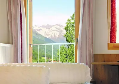 a room with a window with a view of a mountain at Pension Alpenhof B&B in Colle Isarco