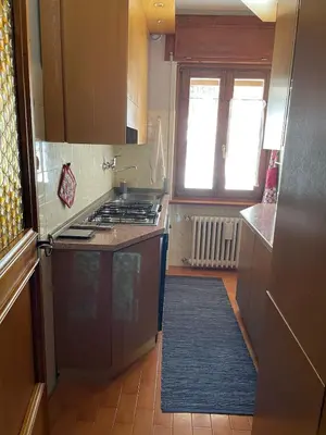 a small kitchen with a stove and a window at Villa Istria Apartment in San Vito di Cadore