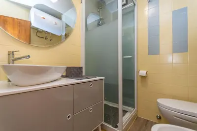 a bathroom with a sink and a shower at Chalet Baranci in Pozza di Fassa