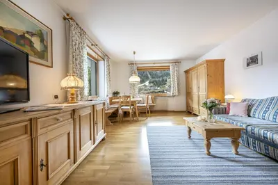 a living room with a couch and a tv at Panorama Apartments Walter in Ortisei