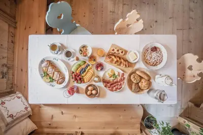 a bunch of different types of food on a table at Ciasa Somuer in San Vigilio Di Marebbe