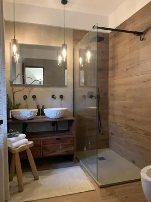 a bathroom with a glass shower and a sink at DHome in Agordo