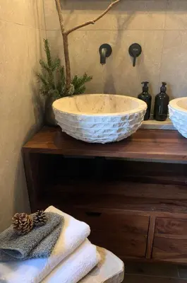 a bathroom with a bowl sink on a counter at DHome in Agordo