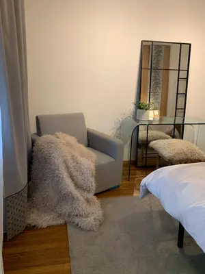 a living room with a couch and a mirror at DHome in Agordo