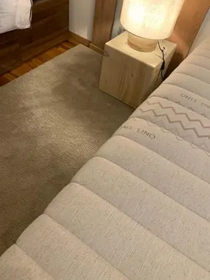 a bedroom with a bed with a lamp on a table at DHome in Agordo