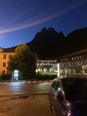a car parked in a parking lot in front of a building at DHome in Agordo