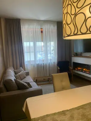 a living room with a couch and a fireplace at DHome in Agordo