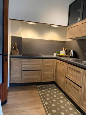 a kitchen with wooden cabinets and a sink at DHome in Agordo