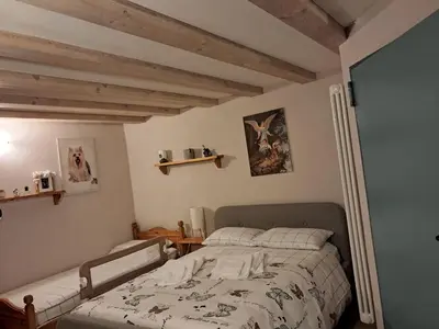 a bedroom with a bed in a room with wooden ceilings at Casa Anelis in Bedollo