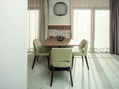 a dining room with a wooden table and chairs at Corones Suites - Dolomites Residence in Valdaora