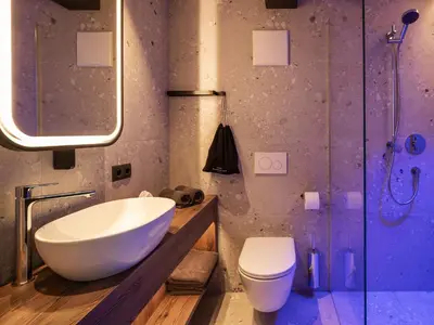 a bathroom with a sink and a toilet and a shower at Corones Suites - Dolomites Residence in Valdaora