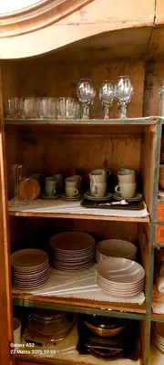 a shelf filled with plates and glasses and dishes at Villa Serena in San Vito di Cadore