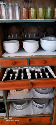 a wooden shelf with plates and bowls on it at Villa Serena in San Vito di Cadore
