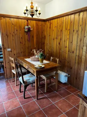 a dining room with a wooden table and chairs at Villa Serena in San Vito di Cadore