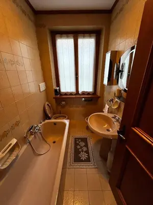 a bathroom with a tub and a toilet and a sink at Villa Serena in San Vito di Cadore