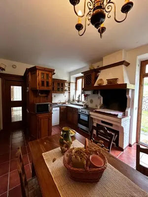 a kitchen with a table with a basket of food on it at Villa Serena in San Vito di Cadore