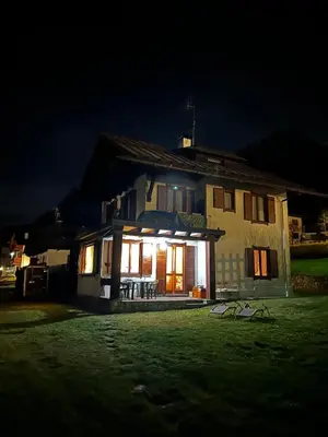 a house with the lights on at night at Villa Serena in San Vito di Cadore