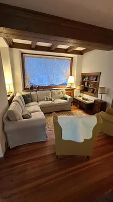 a living room with two couches and a large window at Villa Serena in San Vito di Cadore