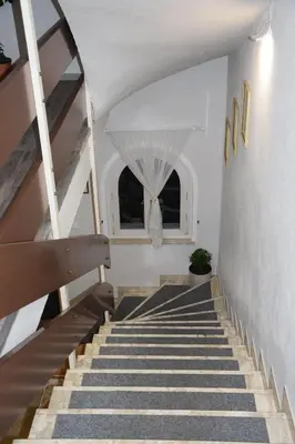 a staircase leading up to a building with two windows at Hotel Mondschein in Plaus