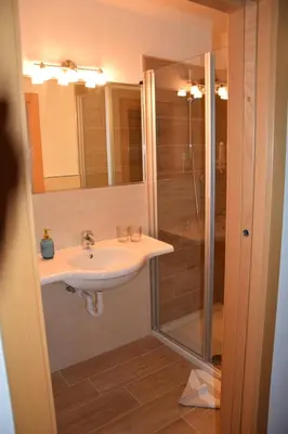 a bathroom with a sink and a shower at Hotel Mondschein in Plaus