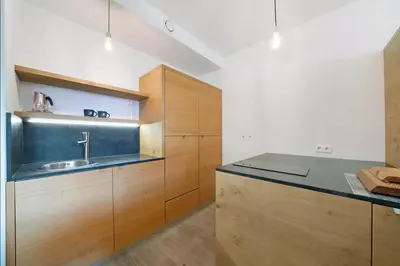 a kitchen with wooden cabinets and a sink at Dahoam - Relaxsuite in Schenna