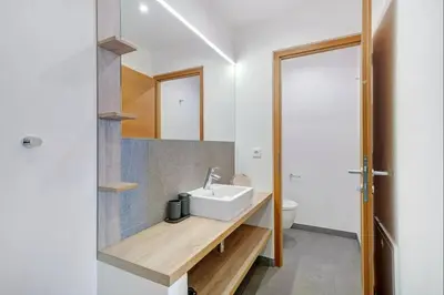 a bathroom with a sink and a toilet at Dahoam - Relaxsuite in Schenna