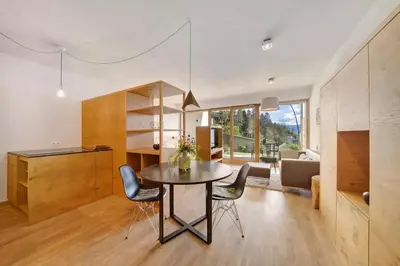 a kitchen and dining room with a table and chairs at Dahoam - Relaxsuite in Schenna