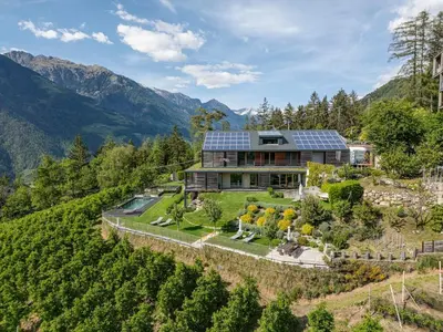a house with solar panels on top of a mountain at Dahoam - Relaxsuite in Schenna
