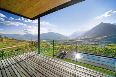 a balcony with a view of the mountains at Dahoam - Panoramasuite in Schenna