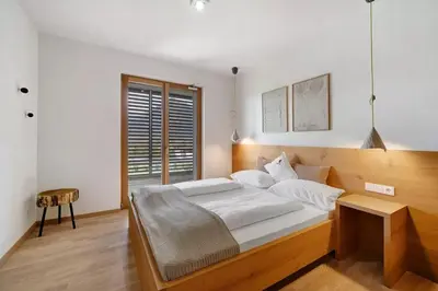 a bedroom with a large bed and a window at Dahoam - Gardensuite R in Schenna