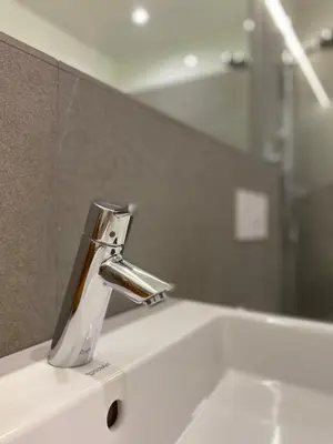 a bathroom sink with a chrome bathroom faucet at Dahoam - Gardensuite R in Schenna