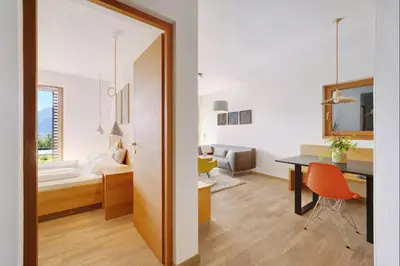 a room with a desk and a room with a bedroom at Dahoam - Gardensuite L in Schenna