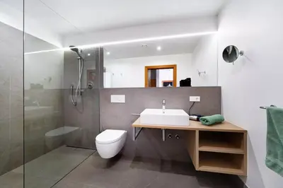 a bathroom with a sink and a toilet and a shower at Dahoam - Gardensuite L in Schenna