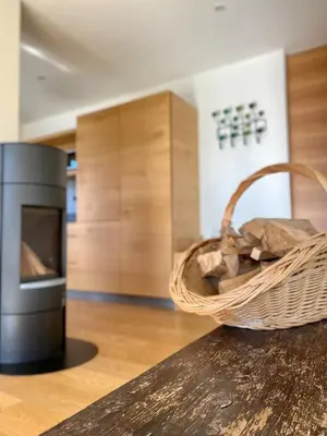 a basket of bread sitting on a counter next to a oven at Dahoam - Gardenchalet in Schenna