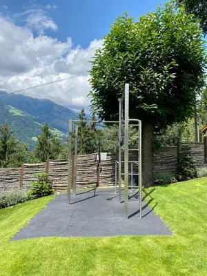 a batting cage in the middle of a yard at Dahoam - Panoramchalet in Schenna