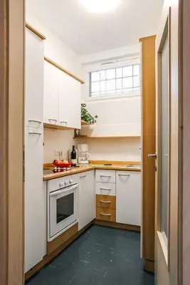 a kitchen with white cabinets and a stove at Andreas Hofer Residence in Bolzano