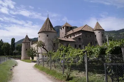 a large castle with a fence in front of it at Andreas Hofer Residence in Bolzano