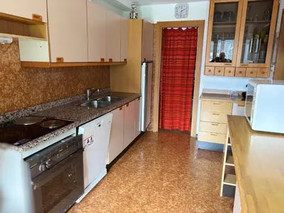 a kitchen with a sink and a stove top oven at Casa Rizzi in Campitello di Fassa