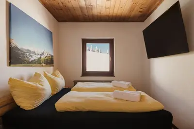 a bedroom with a bed with two pillows on it at Incisa Lodge in Corvara in Badia
