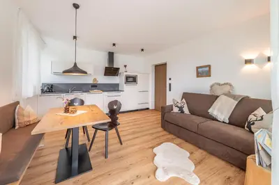 a living room with a couch and a table at Haus Karin living in Brixen