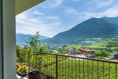 a balcony with a view of a valley and mountains at Haus Karin living in Brixen