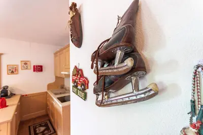 a bag hanging on a wall in a kitchen at Casa Sot Croze in Pozza di Fassa