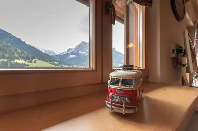 a toy car sitting on a table in front of a window at Casa Sot Croze in Pozza di Fassa