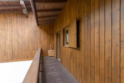 a hallway of a building with a wooden wall at Casa Sot Croze in Pozza di Fassa