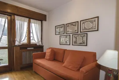 a living room with a couch and some pictures on the wall at Ca de Rupe in Chiave