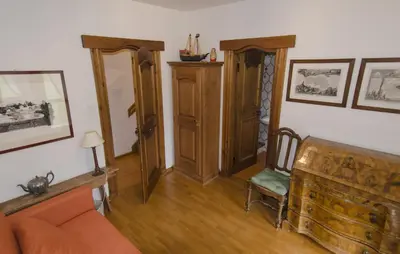 a living room with a couch and a chair at Ca de Rupe in Chiave