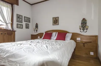 a bedroom with a large white bed with red pillows at Ca de Rupe in Chiave