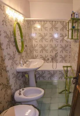 a bathroom with a toilet and a sink at Ca de Rupe in Chiave
