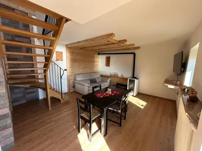 a living room with a table and a couch at La Casa del Zio Bepi in Bedollo