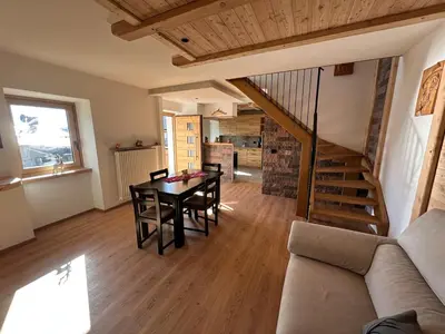 a living room with a table and a couch at La Casa del Zio Bepi in Bedollo